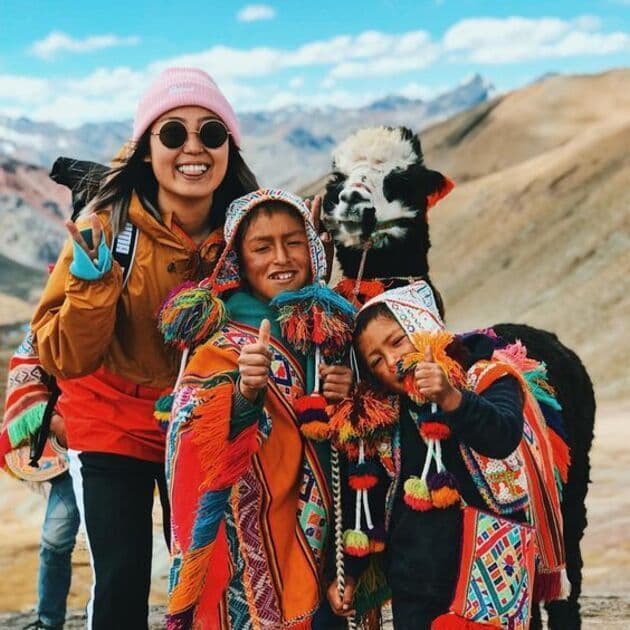 Tourists exploring Vinicunca in the company of children